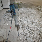 Removing,Concrete,Floor,With,Jackhammer,Tool.,Concrete,Rubble,Debris,On
