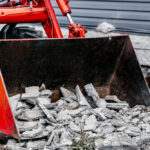 Removal,Of,Construction,Debris.,The,Bucket,Of,The,Tractor,Is