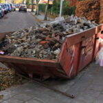 Loaded,Dumpster,Near,A,Construction,Site,,Home,Renovation
